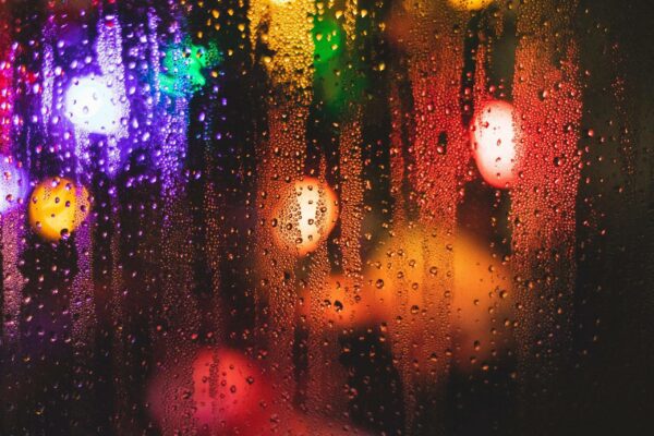 Tulsa Christmas Lights - Rain drops on a window with colorful lights.